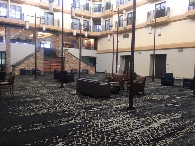 Another view of the hotel atrium showing the staircase leading down into the space.